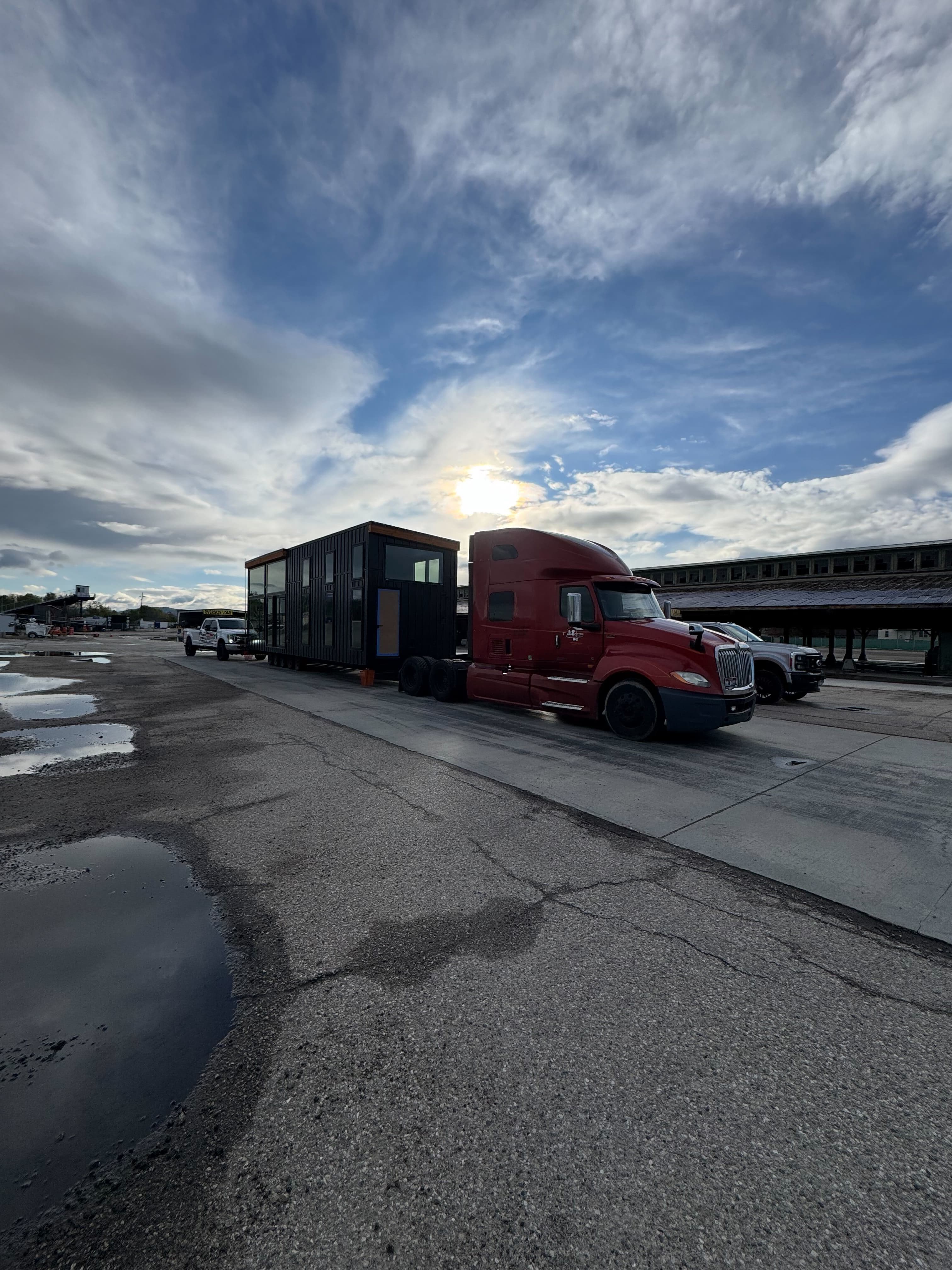 Montera Homes factory — semi-truck staged with modular home ready for delivery