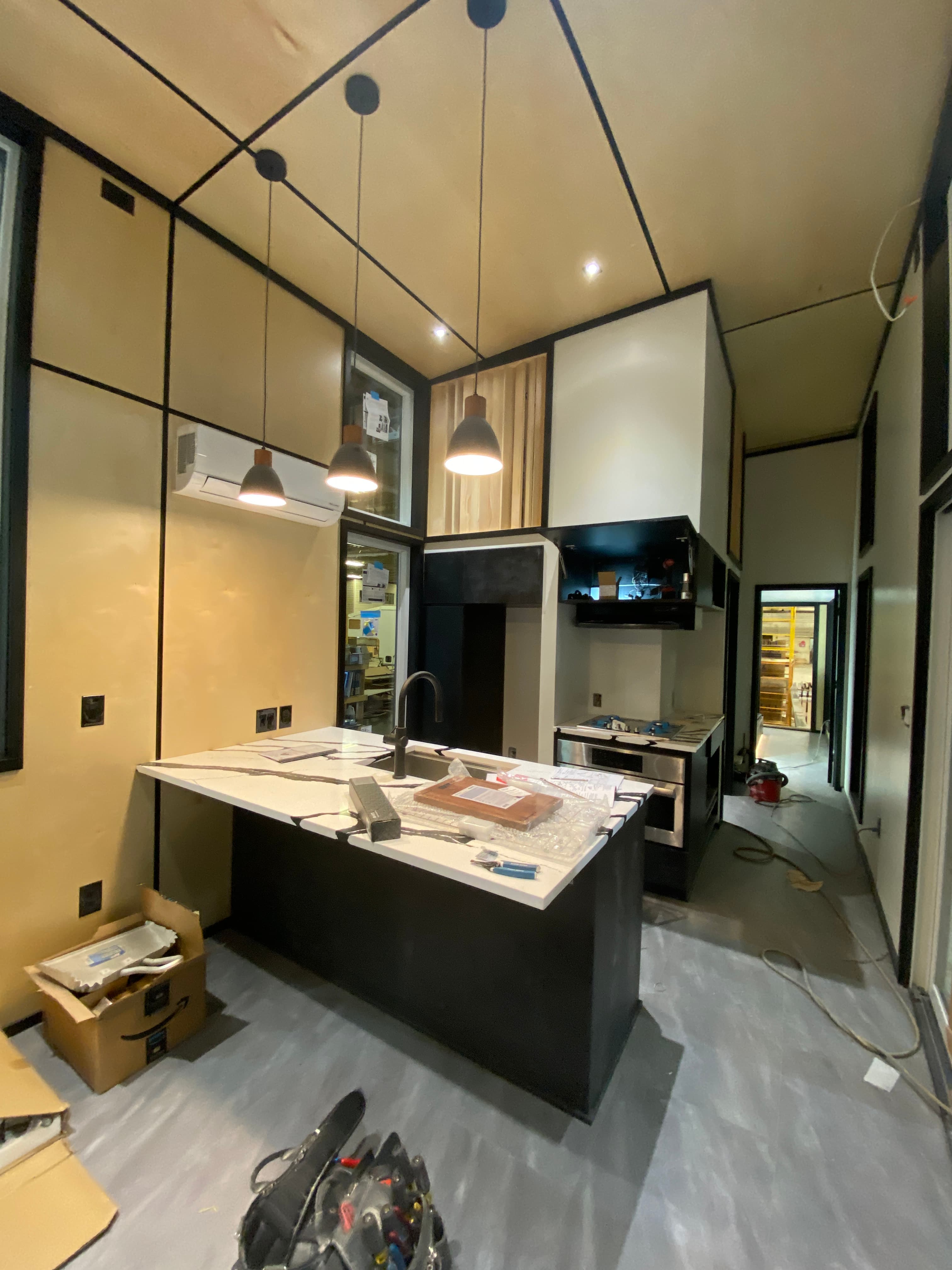 Montera Homes factory build — kitchen island and cabinetry install stage