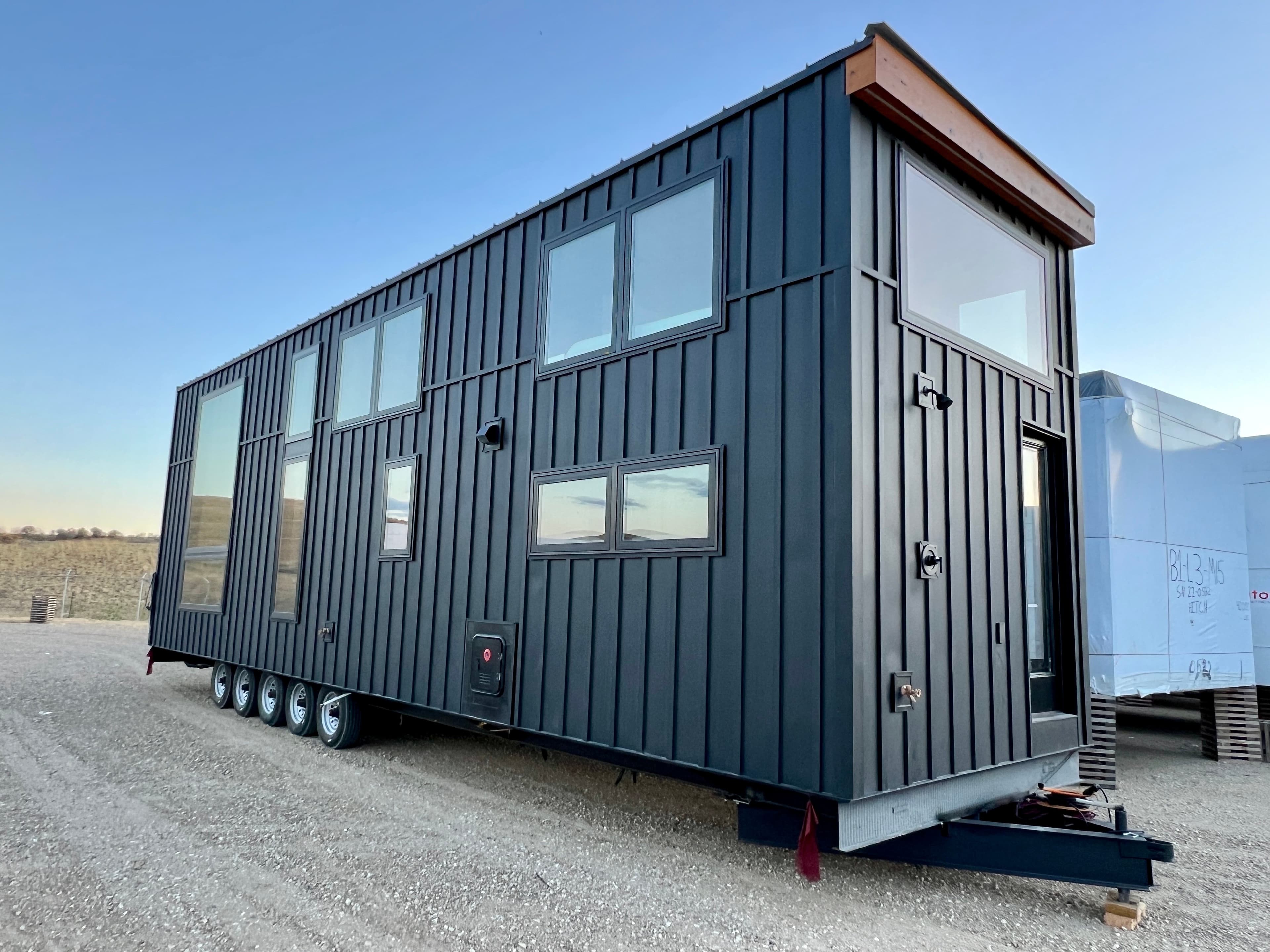 Montera modular home exterior — front elevation with large windows and metal roofing