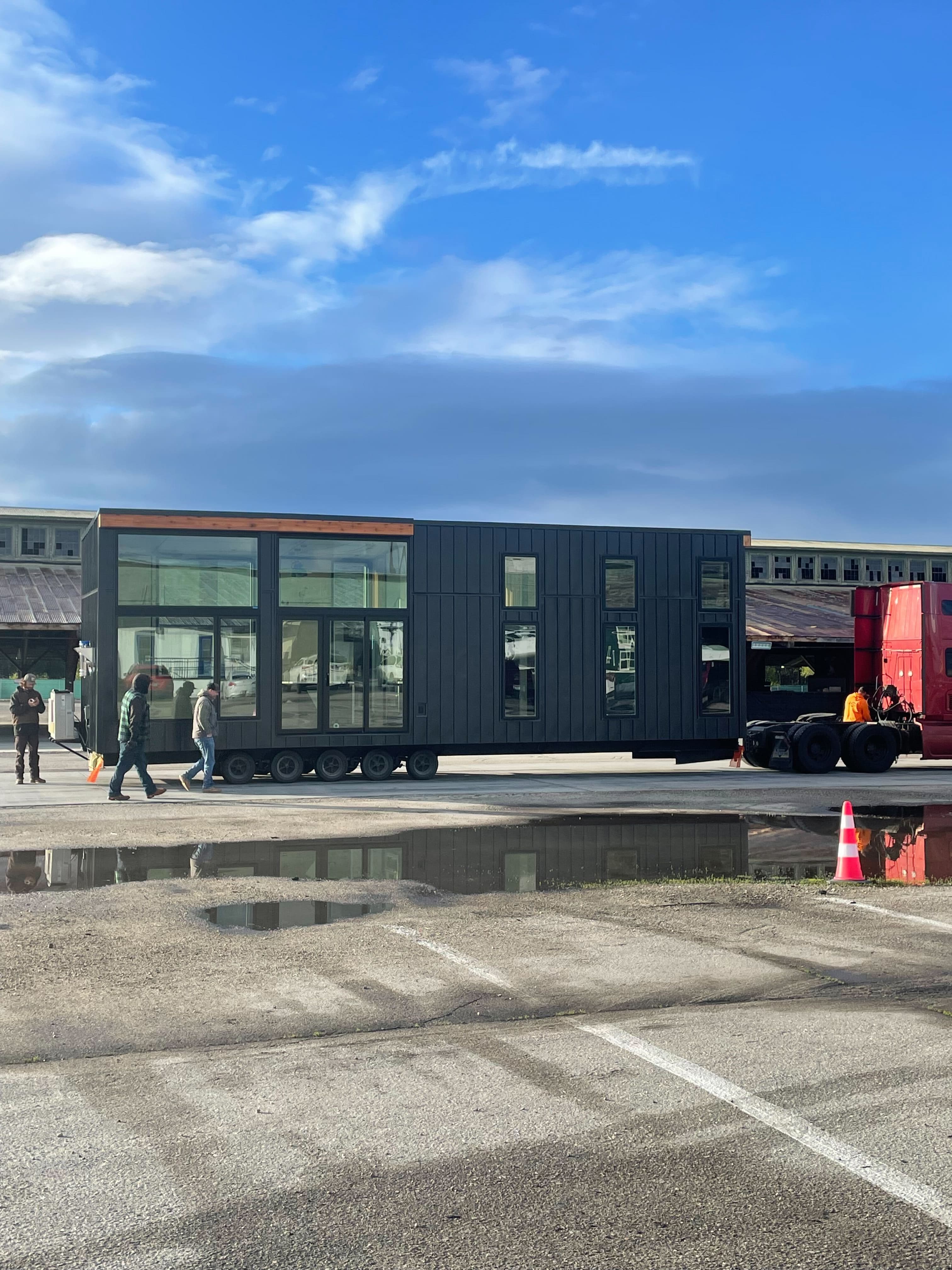 Montera modular home exterior — side elevation with large windows on factory pad