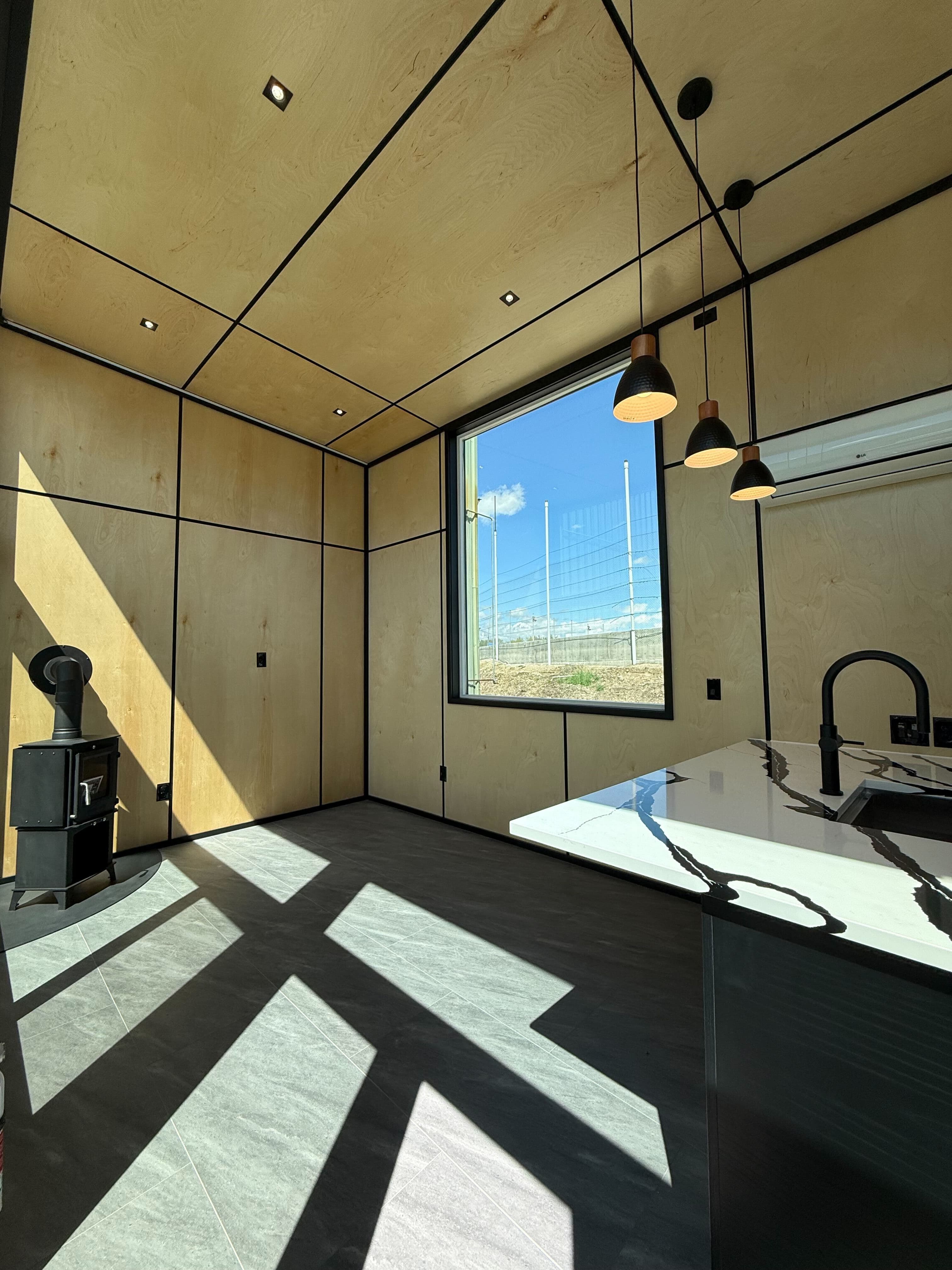 Montera modular home interior — living space with large window and mountain view